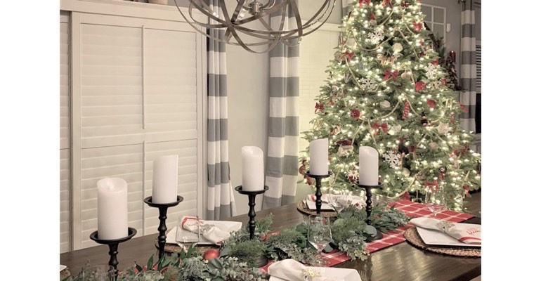 Christmas table with candles in festive dining room. 